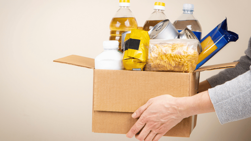 Palm Coast Food Pantries Are Running Low: Here’s How You Can Help person handing out food to the needy in palm coast, florida