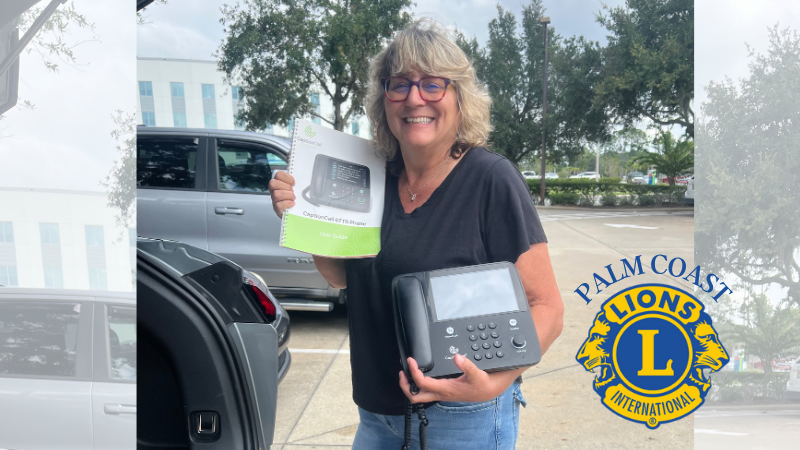 Cathy McDermott, owner of Hear for You Mobile Audiology, gave a donation of a CaptionCall phone, a specialized device designed for individuals with hearing loss. Cathy McDermott Holding CaptionCall Phone for donation.