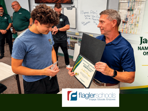 Flagler Palm Coast High School’s Phil DeAugustino presents Jackson Magee with recognition for being named a Semifinalist in the 2027 National Merit Scholarship Program on PalmCoastLocal.com.