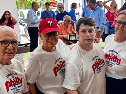 Customers, community members, and local supporters gather inside Original Philly Cheesesteak of Florida during the grand opening celebration at the new Palm Coast restaurant location.