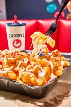 signature seasoned crinkle-cut fries topped with fried hand-breaded chicken, a shredded blend of Monterey Jack and cheddar cheese, hardwood-smoked bacon, and creamy buttermilk ranch dressing.